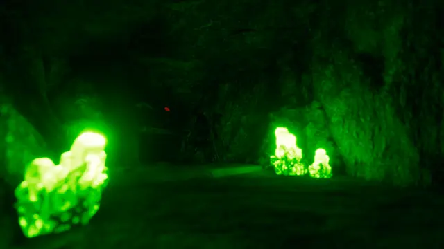 Bright green crystals lighting the floor and walls of a dark cave in The Last Caretaker.